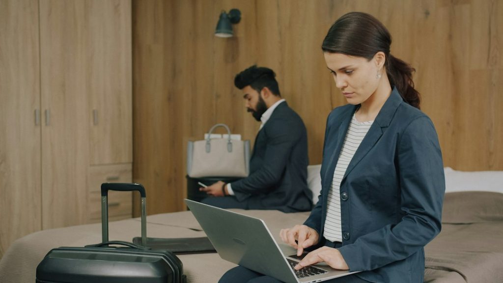 Travel professional reviewing customer loyalty and booking data on a laptop, representing AI-powered loyalty strategy for tourism businesses
