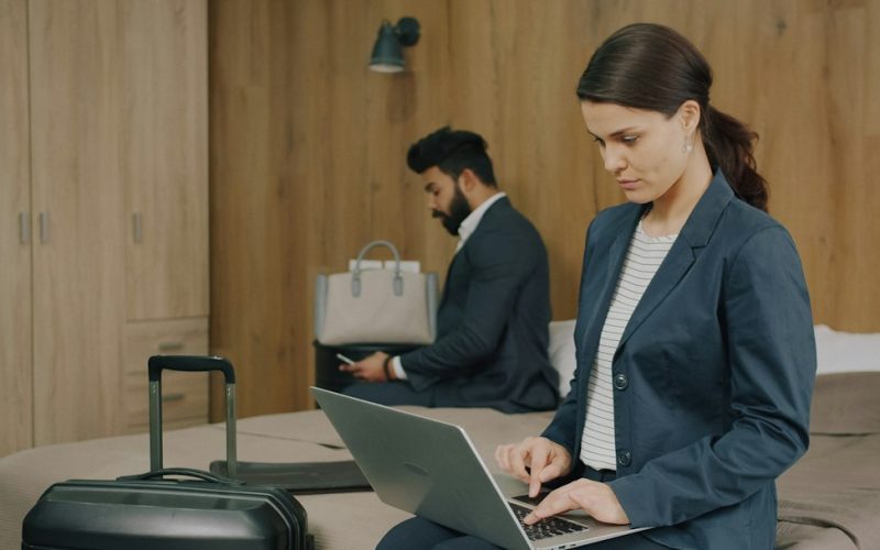 Travel professional reviewing customer loyalty and booking data on a laptop, representing AI-powered loyalty strategy for tourism businesses